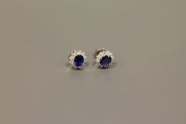 A pair of 18ct white gold sapphire and diamond cluster earrings CONDITION REPORT: