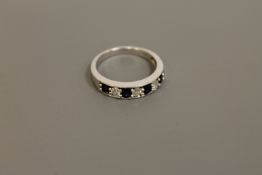 An 18ct white gold sapphire and diamond half eternity ring,