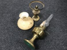 Two brass oil lamps and an odd glass shade