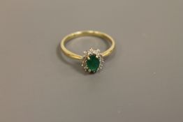 A 9ct gold emerald and diamond cluster ring,