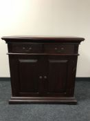 An Indonesian double door sideboard in a mahogany finish