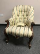 A Victorian armchair upholstered in stripe fabric