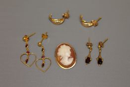 A 14ct gold cameo brooch, together with a pair of garnet earrings,