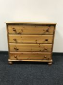 A pine four drawer chest