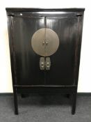 A Chinese lacquered double door cabinet CONDITION REPORT: 175cm high, 109cm wide,