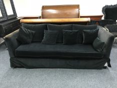 A contemporary bed settee in a black fabric with scatter cushions
