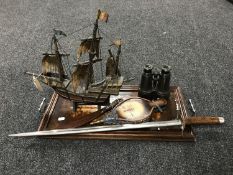 An inlaid mahogany twin handled serving tray, leather bound field glasses, vintage wooden galleon,