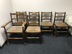 A set of six early twentieth century oak rush seated country chairs.