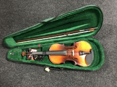 A violin and bow in soft case and a violin music book