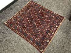 A tribal Gazak rug on red blue ground, 116 cm x 111 cm.