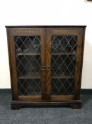 An oak leaded glass door bookcase