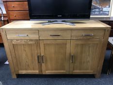A contemporary pine triple door sideboard