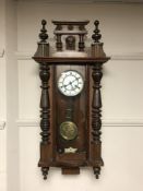 An Edwardian mahogany wall clock with enamelled dial