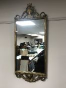 An ornate gilt framed hall mirror