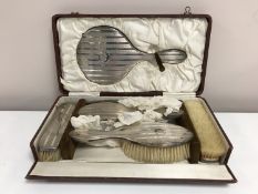 An early twentieth century six piece silver backed dressing table brush set, cased.