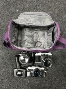 An Olympus OM1 camera with lens, an Olympus OM30 with lens,
