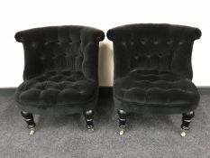 A pair of contemporary button back bedroom chairs in black fabric
