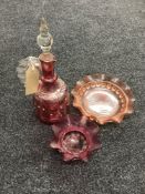 An early 20th century cranberry glass decanter and bowl and a pink glass bowl