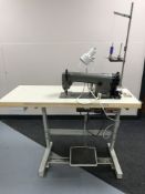 A Brother industrial treadle sewing machine in table