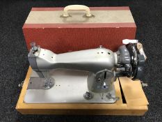 A cased hand sewing machine