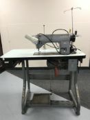 A Singer industrial treadle sewing machine in table