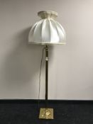 A brass column standard lamp and shade