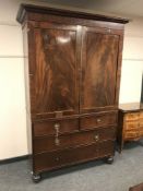 A 19th century inlaid mahogany press, width 136 cm.