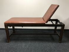 A mid-20th century oak adjustable examination bed