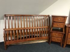 A contemporary stained 5' rail bed and a pair of two drawer bedside chests