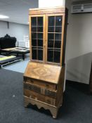 A 20th century walnut bureau bookcase on associated base