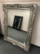 A large silvered overmantel mirror in ornate frame,