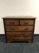 An Edwardian walnut four drawer chest