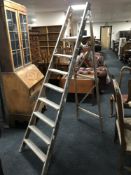 A set of folding wooden step ladders
