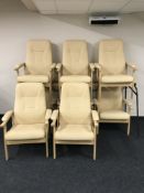 Eight beech framed high backed armchairs