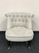 A contemporary button back bedroom chair in beige fabric