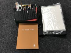 An artist's bag and a box of brushes,