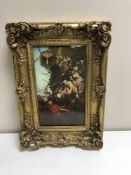 An ornate gilt framed ceramic panel depicting soldiers leaving a ship