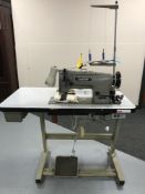 A Brother industrial treadle sewing machine in table