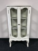 A cream French style double door display cabinet