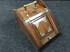 An early 20th century mahogany coal receiver with liner containing leather horse strap with bit