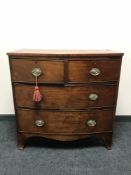 A Victorian inlaid mahogany bowfronted four drawer chest