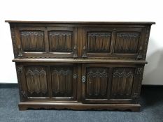 A carved oak linen fold secretaire cocktail sideboard CONDITION REPORT: 110cm high