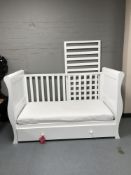 A white child's cot fitted a drawer and mattress
