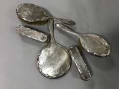 A five piece silver backed dressing table set