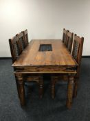 A pine dining table with wrought iron fittings and six chairs