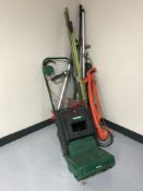 A Qualcast electric lawn raker with box, Flymo strimmer, garden tools,