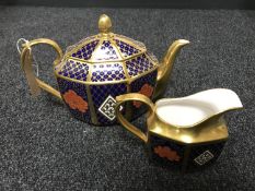 A Caverswall teapot and sugar basin decorated in Romany 22ct gold leaf.