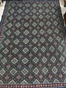 A fringed woollen Turkish rug of geometric design on blue ground