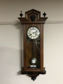 A walnut cased eight day wall clock with enamel dial