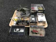 A tray of nine James Bond die cast vehicles in plastic display cases together with a James Bond